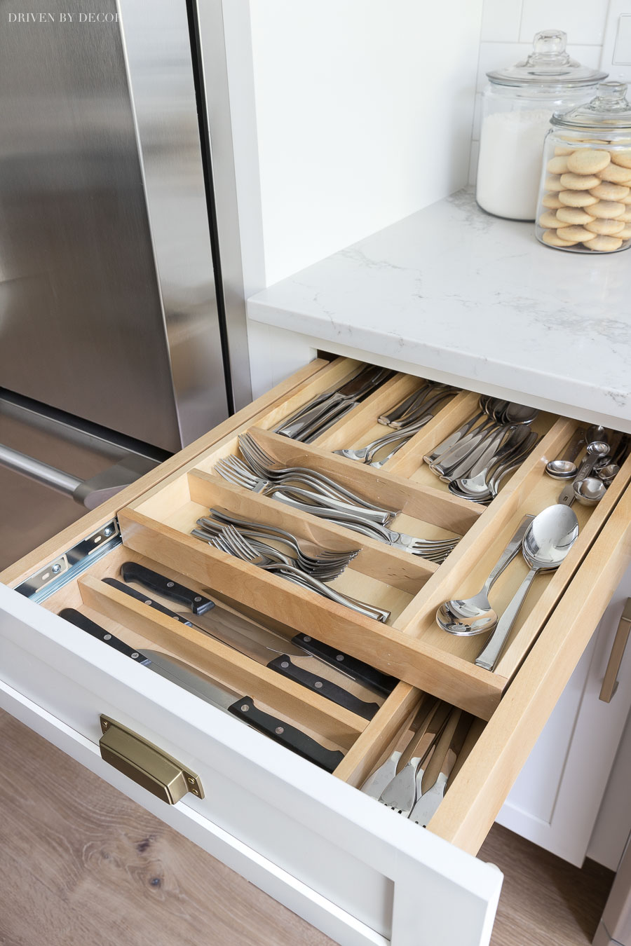 https://www.drivenbydecor.com/wp-content/uploads/2018/08/kitchen-cabinet-two-tier-cutlery-silverware-divided-drawer.jpg