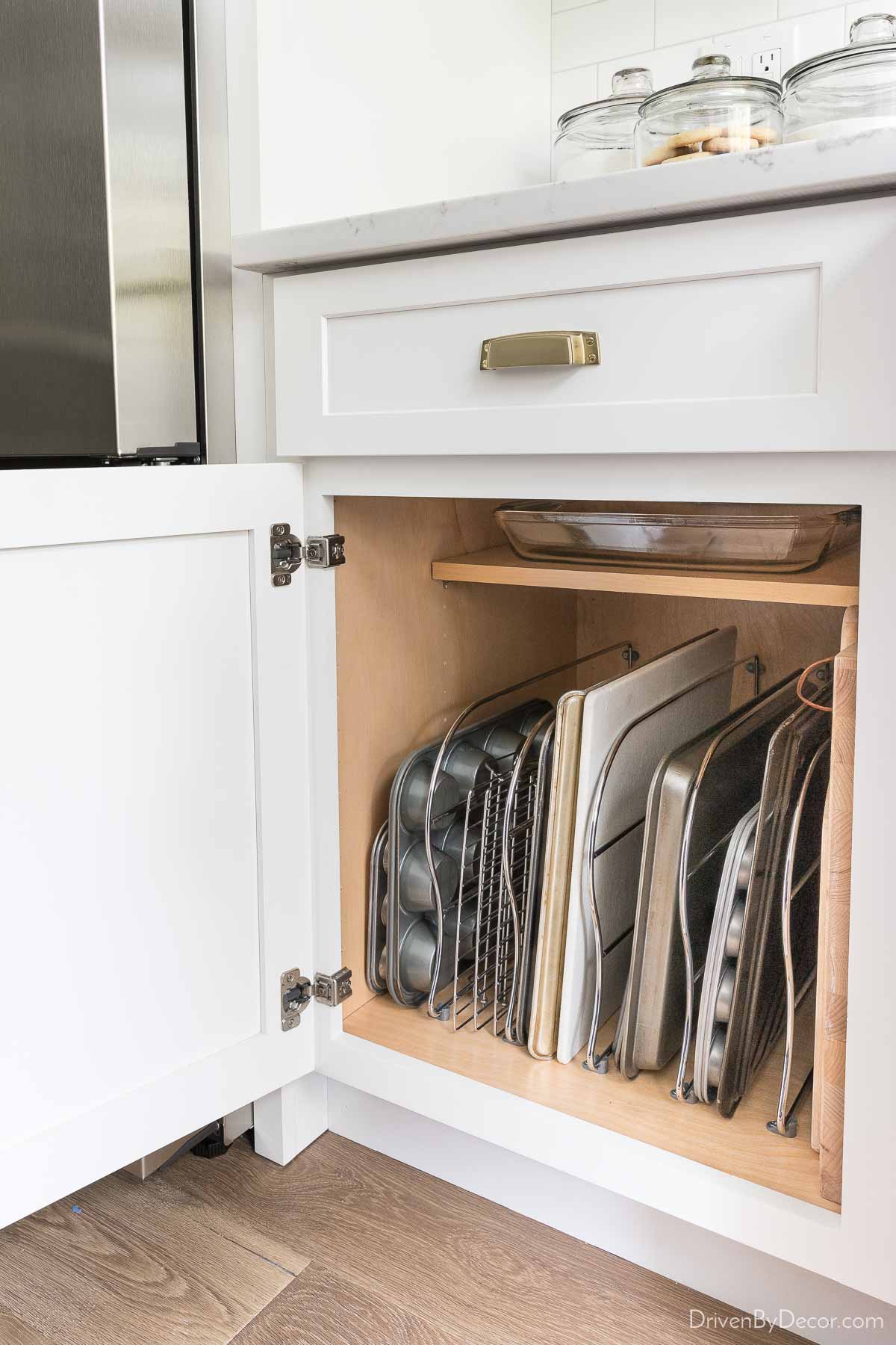 https://www.drivenbydecor.com/wp-content/uploads/2022/02/kitchen-cabinet-organization-baking-sheet-dividers.jpg