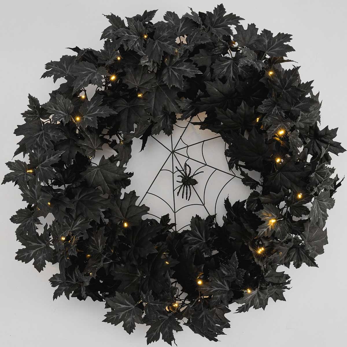 Halloween wreath with black leaves and spider web