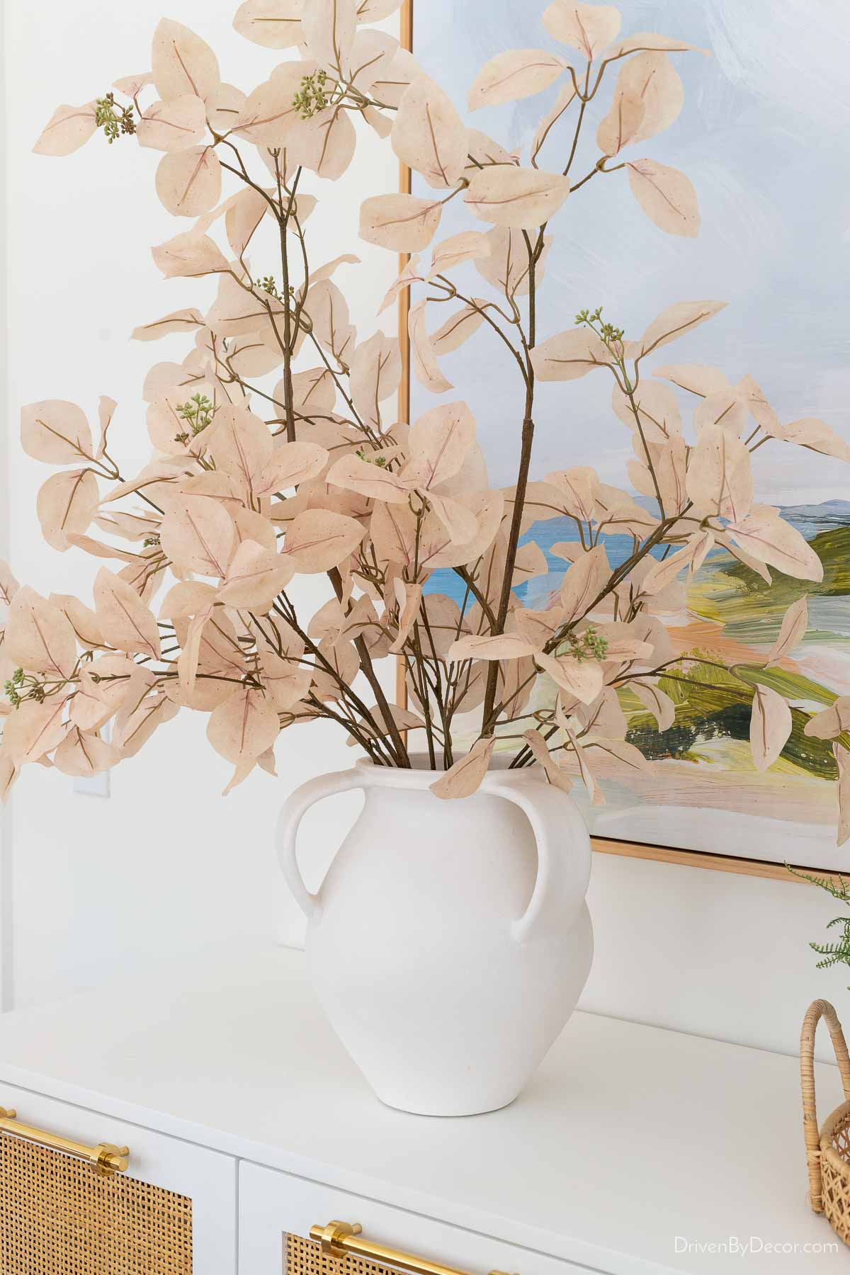 White vase with faux leafy branches